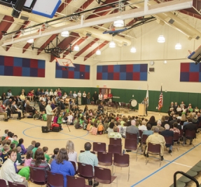 an assembly in the gym of the elementary school