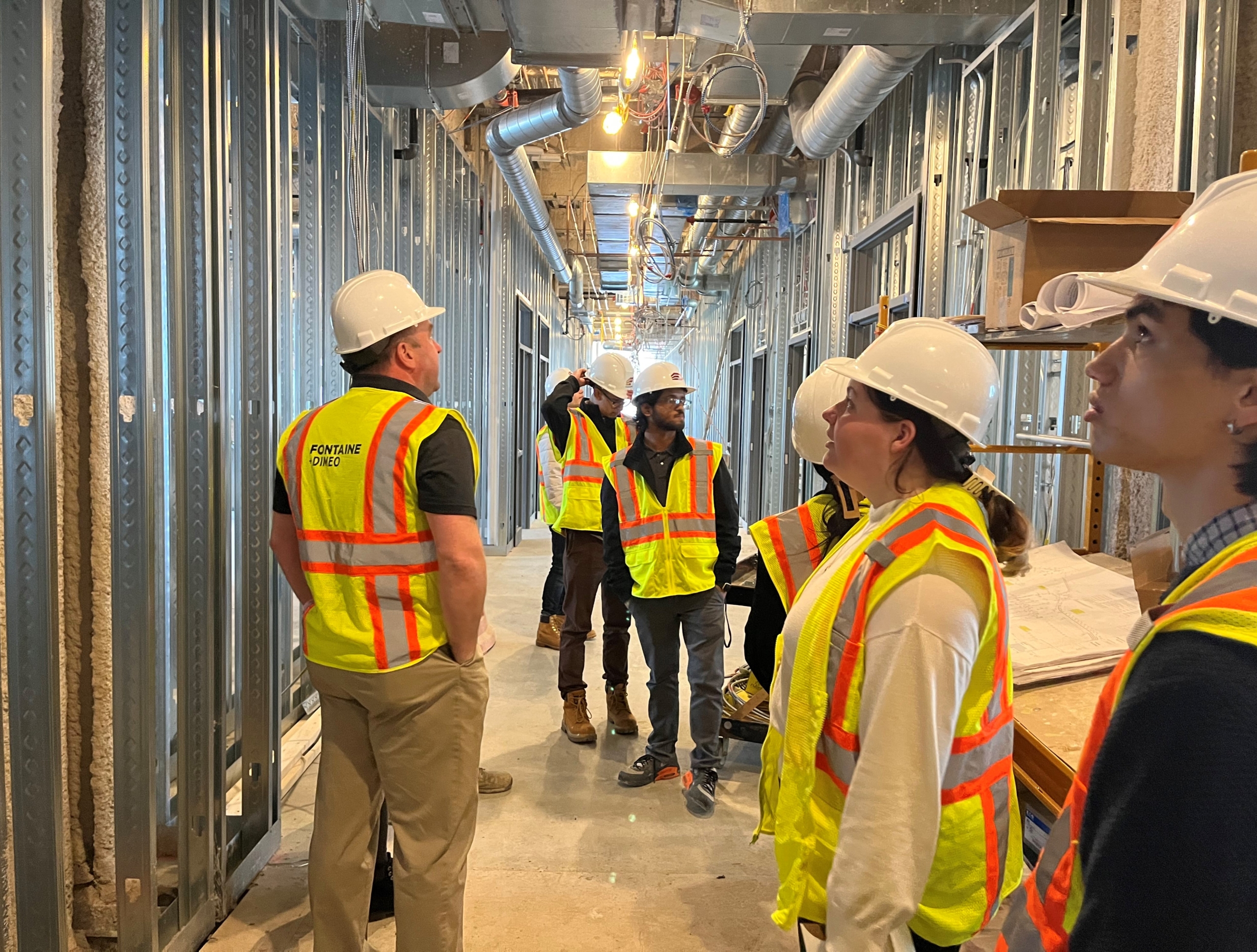 college students touring the construction site of Doherty High School