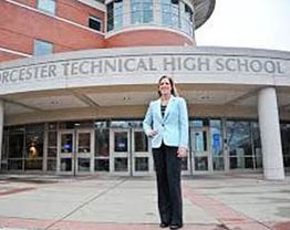 Sheila Harrity stand in front of the entrance of the Worcester Technical High School