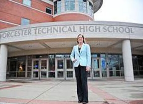 Sheila Harrity stand in front of the entrance of the Worcester Technical High School