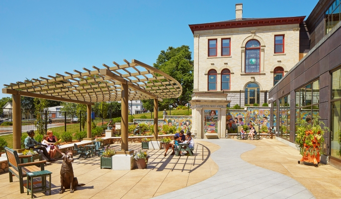 outdoor area of Shrewsbury Public library features sculptures and colorful murals