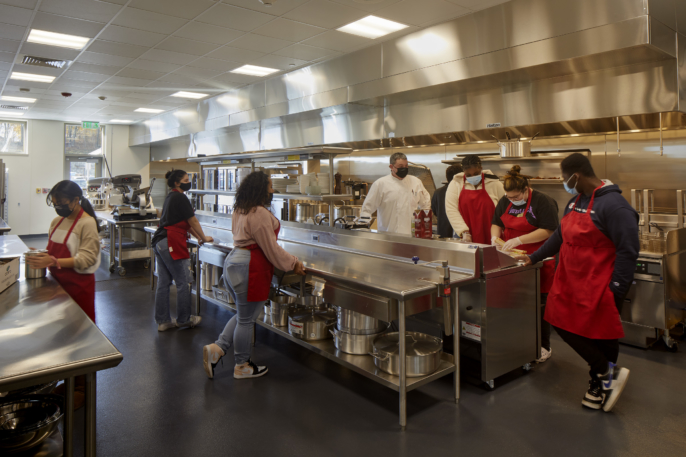 culinary students learning in a commercial kitchen