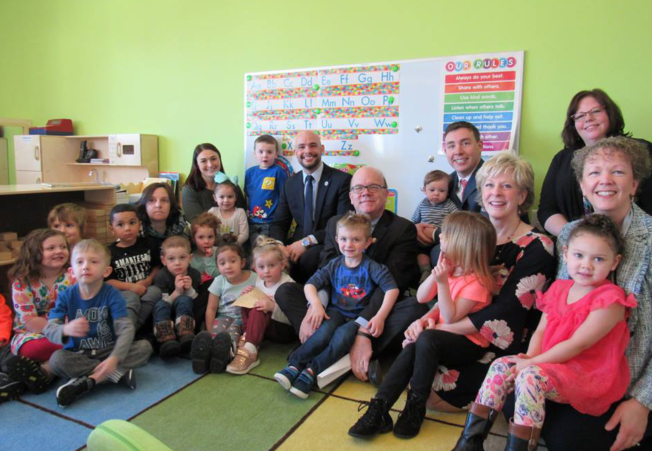 young children gather with local leadership as part of a head start program
