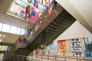 the lobby of South High School looking up at the flags display from under the staircase