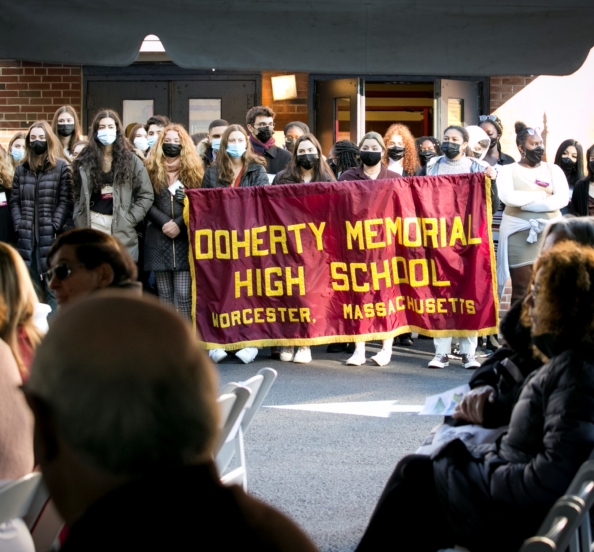 students hold a banner that reads "Doherty Memorial High School."