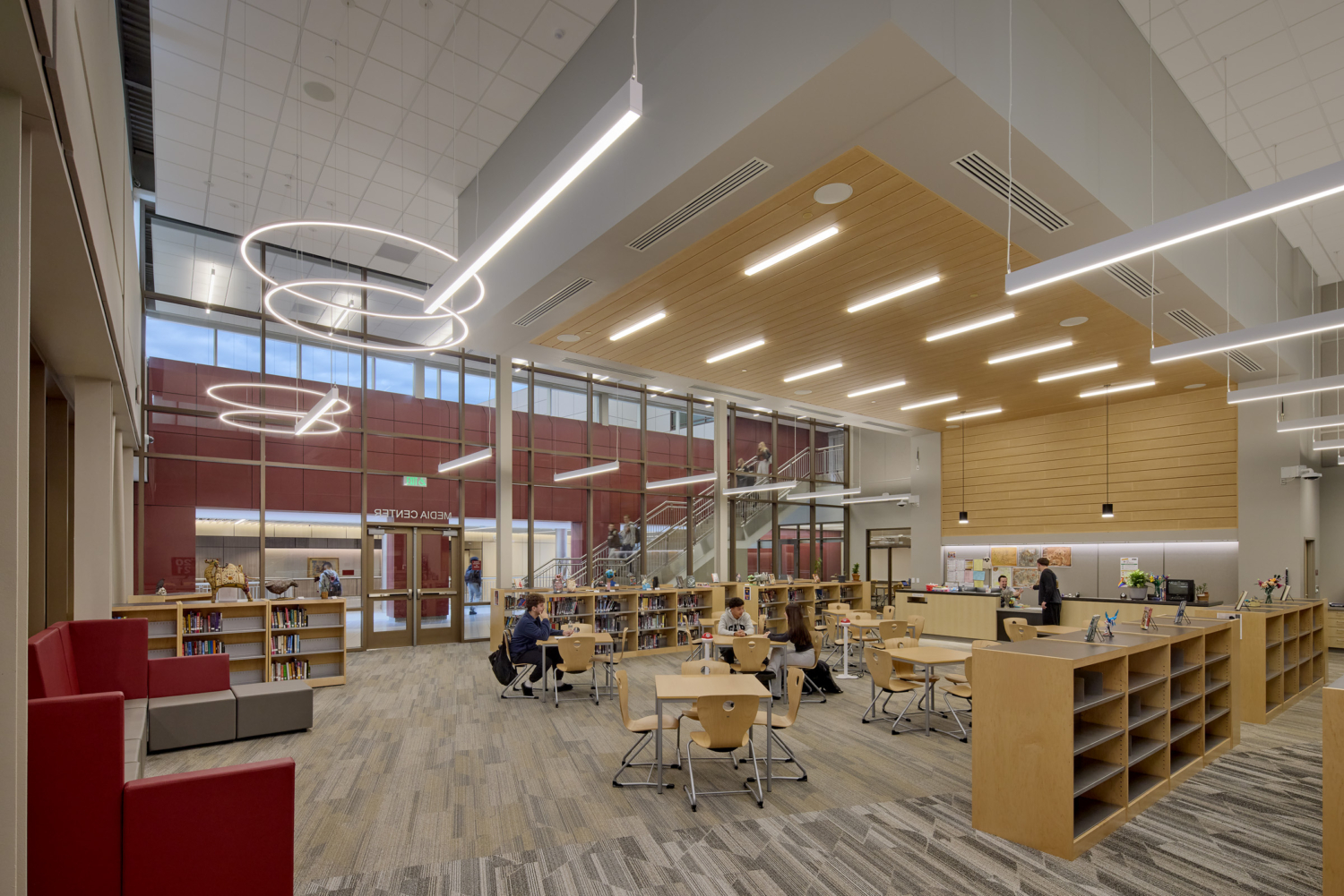 Doherty High School's Media Center; people sitting at small tables next to full bookshelves