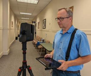 mike williams using a matterport in a hallway