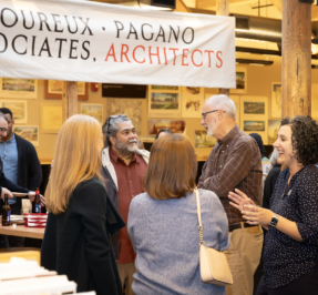 a party scene in an office with small groups of people in conversation