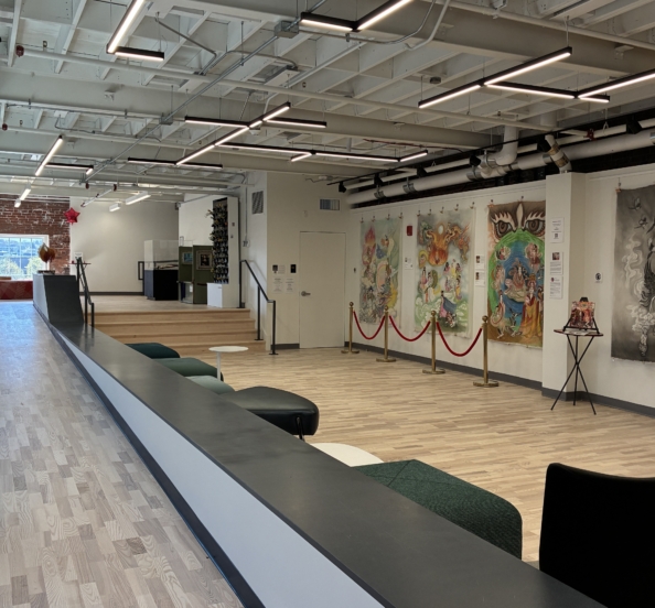the creative hub lobby and art gallery shows wood floors and light from windows to the right